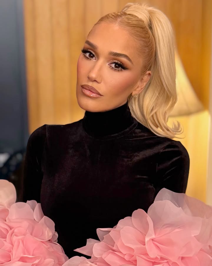 May be an image of one or more people, blonde hair, eyeliner, makeup, turtleneck and text