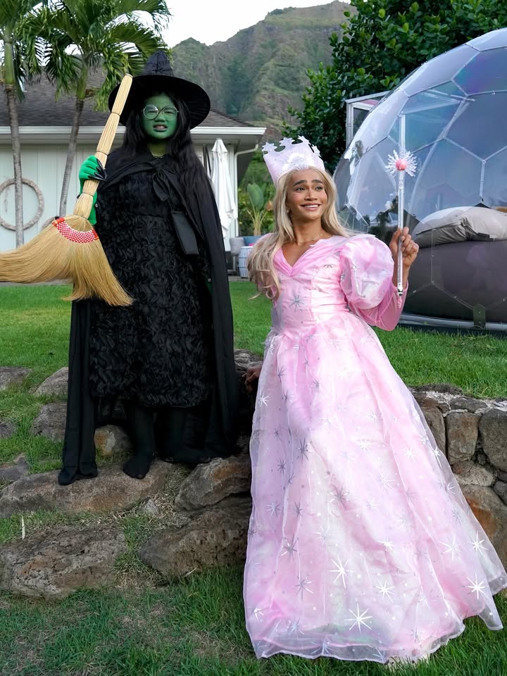 May be an image of headdress, parasol, costume, cloak, scarecrow and gown