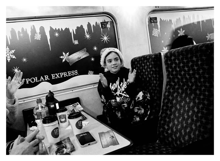 May be a black-and-white image of one or more people, train, bus and text