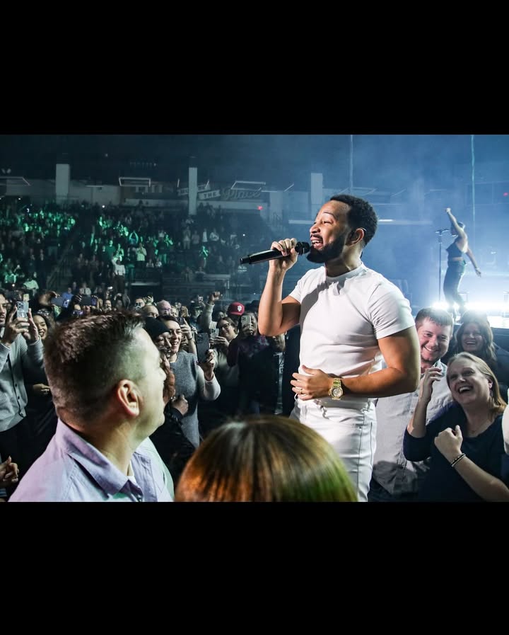 May be an image of one or more people, microphone, crowd, concert and text