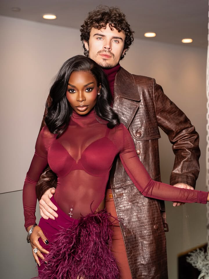 May be an image of one or more people, makeup, leather, gown, dress and text