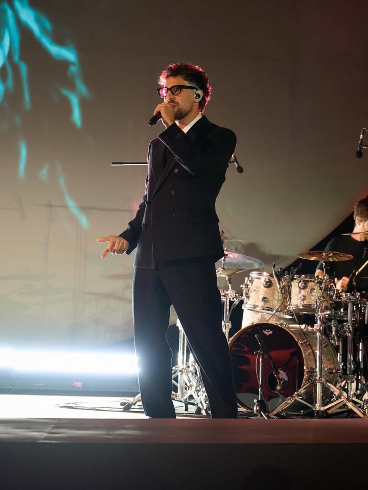 May be an image of microphone, concert and text