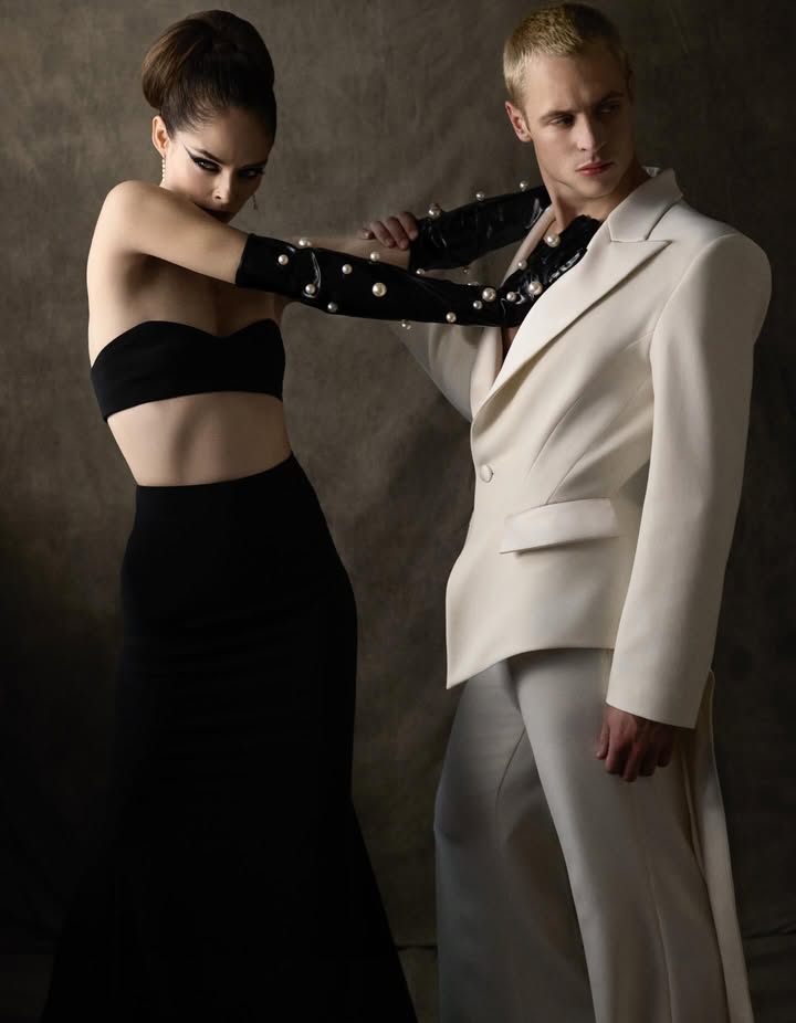 May be an image of one or more people, makeup, suit, gown, dinner jacket and text