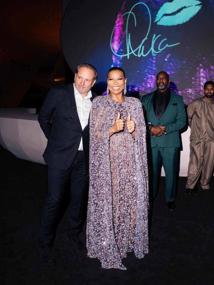 May be an image of one or more people, makeup, dress, carpet, gown, dinner jacket and text