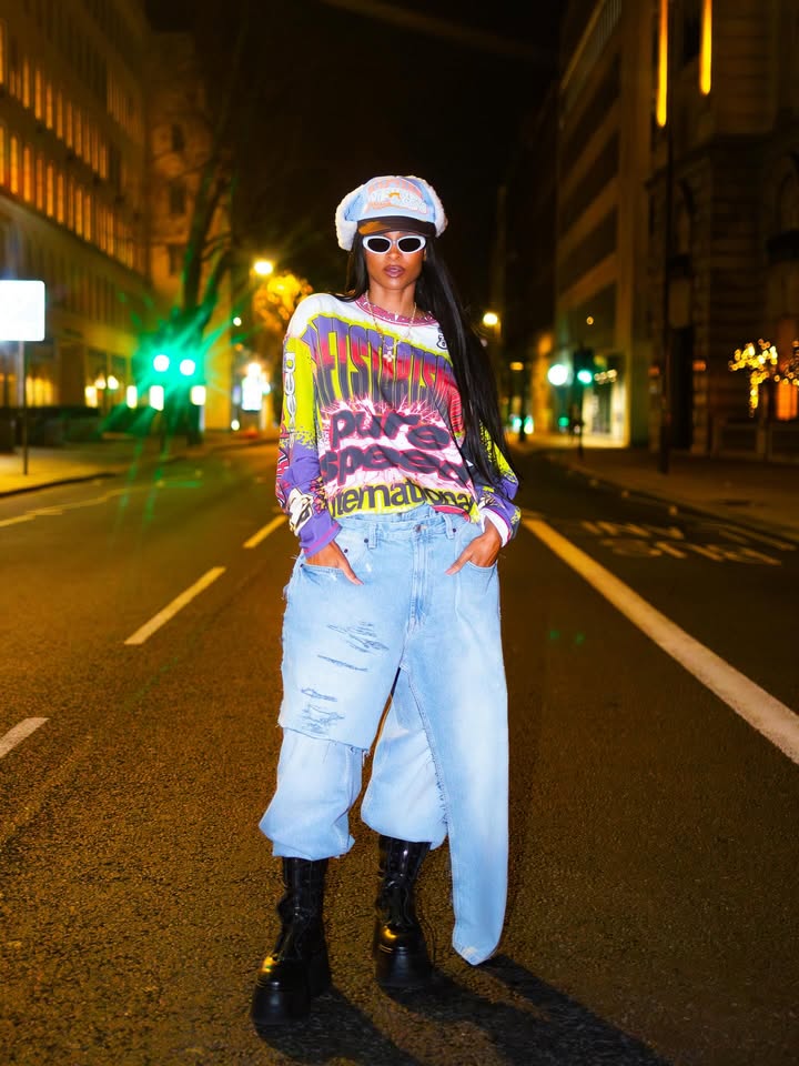 May be an image of eyewear, fishnet stockings, beret, turtleneck, headscarf, street and text