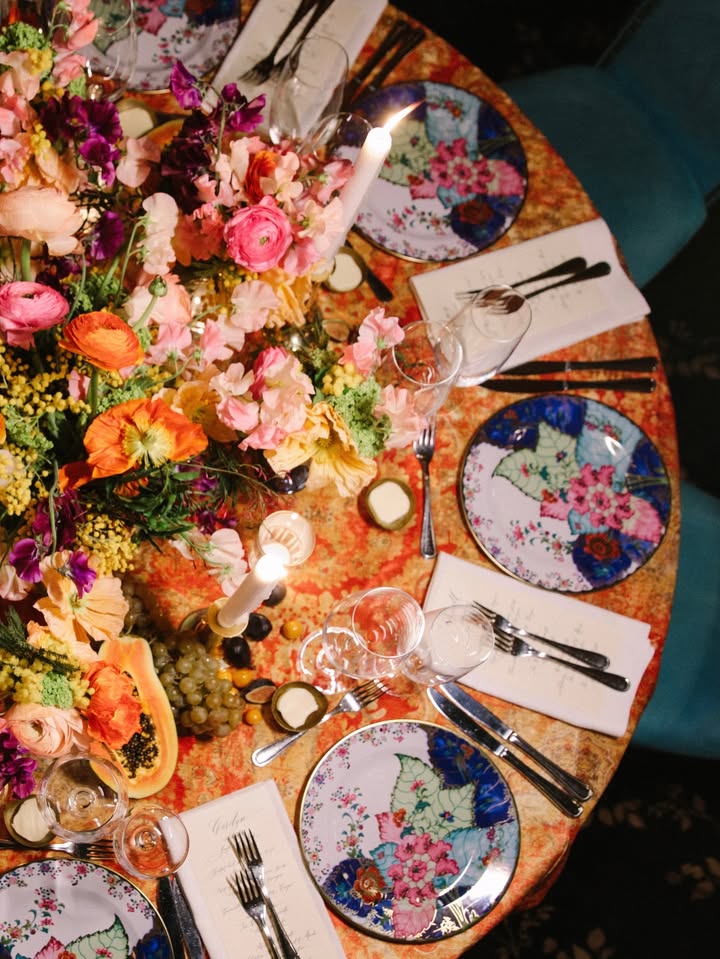 May be an image of candle holder, napkin ring, chinaware, cutlery, placemat, napkin, tablecloth and text