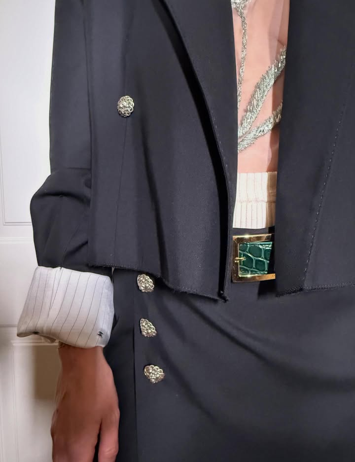 May be an image of blazer and text