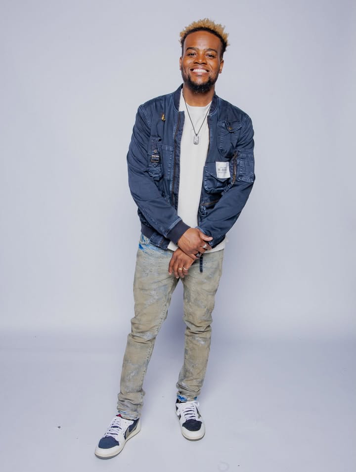 May be an image of one or more people, people smiling, people standing, jacket and text