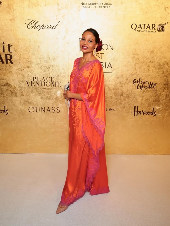 May be an image of ‎dress, gown and ‎text that says '‎NITA NITAMUKESHAMBANI MUKESH AMBANI CULTURAL CULTURALCENTRE CENTRE Chopard QATAR AIRWAYS القطريا 点 R it ON ST BIA PLACE.. VENDONE ds rds Galeriesy lyfugitte OUNASS As Harrods‎'‎‎