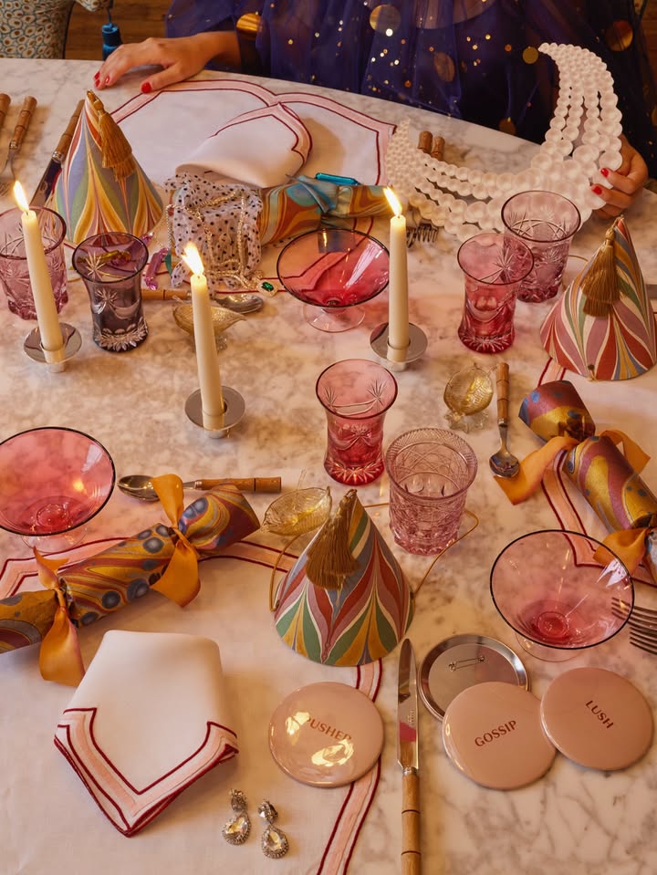 May be an image of napkin ring, candle holder, candle, tablecloth, placemat, goblet, napkin and text