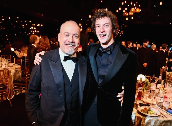 May be an image of suit, dinner jacket and text