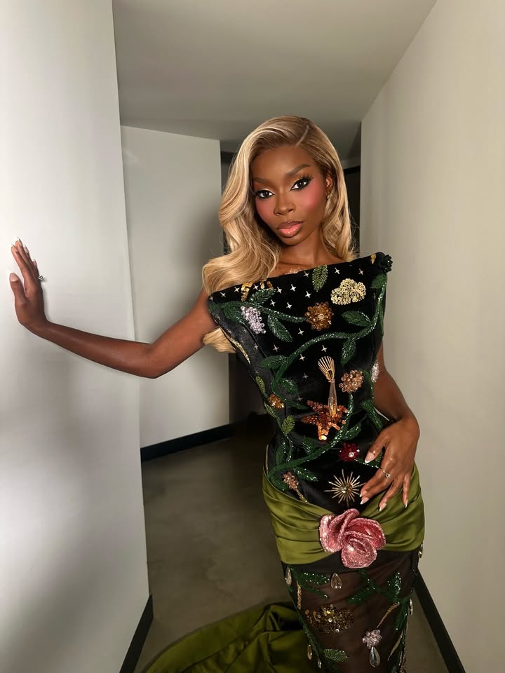 May be an image of one or more people, makeup, gown, dress and text