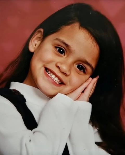 May be an image of bangs, child, smiling, turtleneck and text