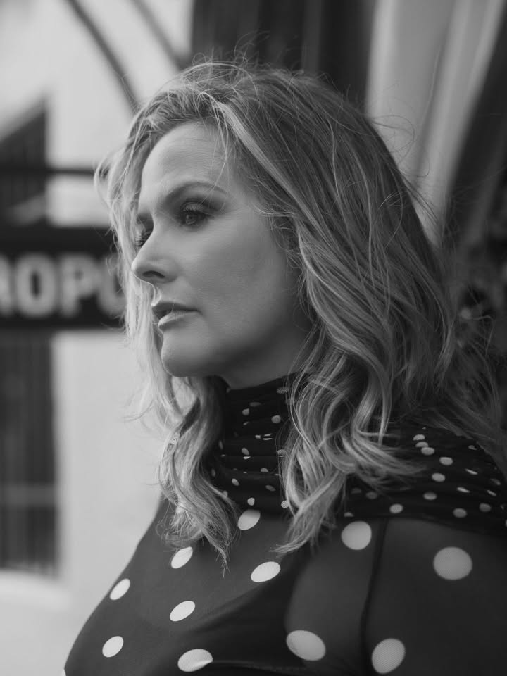 May be a black-and-white image of one or more people, blonde hair, turtleneck and text