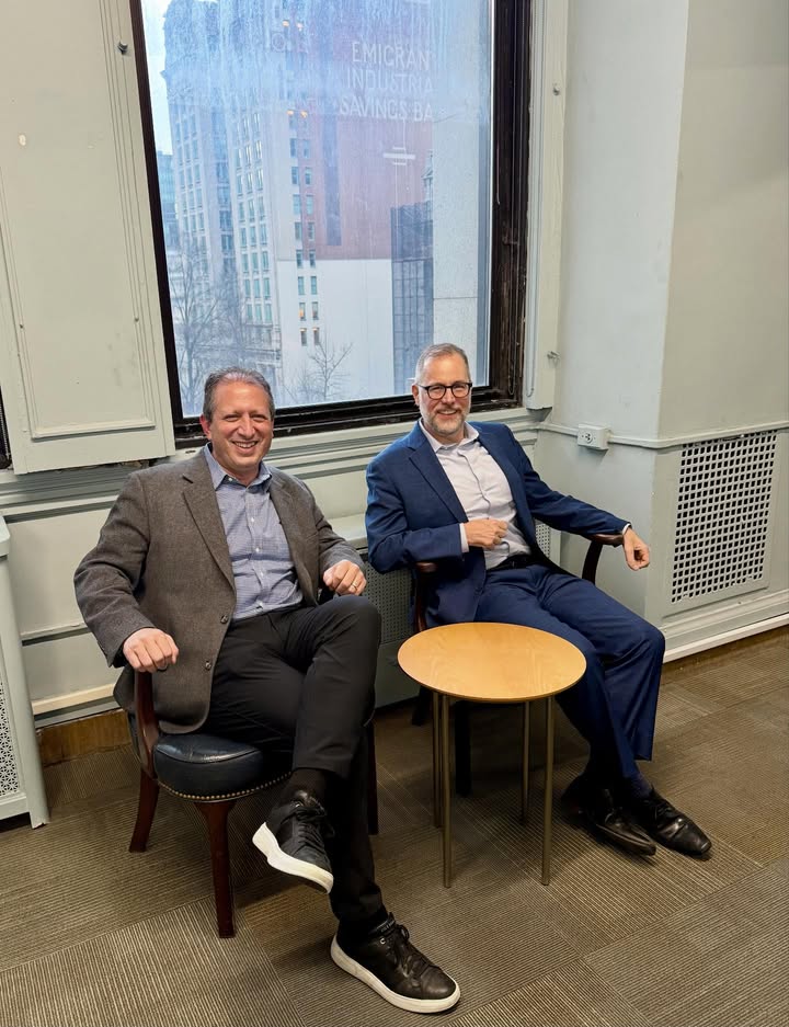 May be an image of suit, office and text