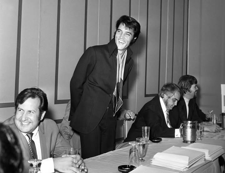 May be an image of smoking, dinner jacket and text