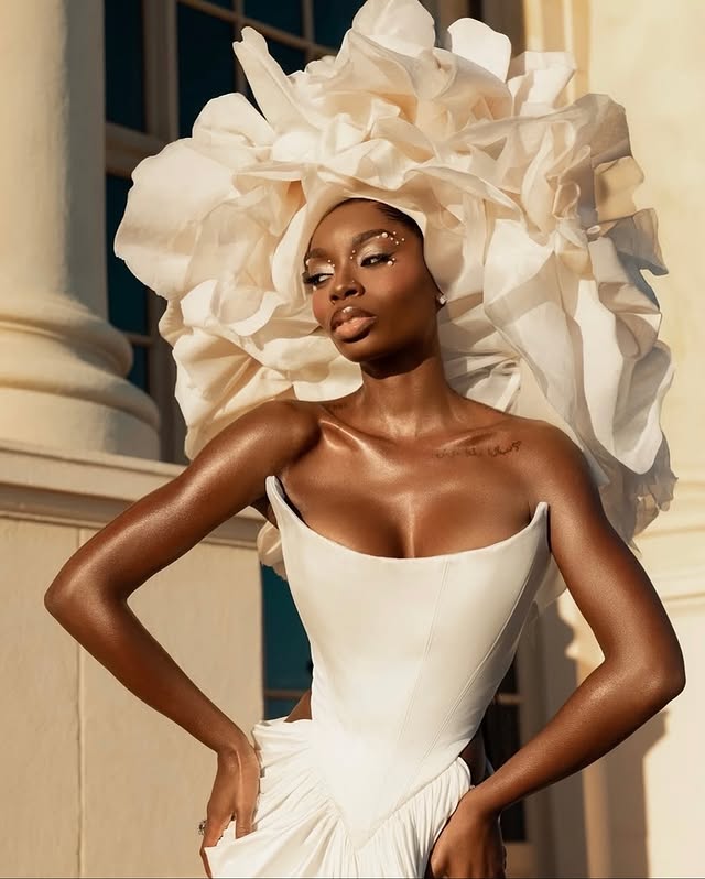 May be an image of one or more people, makeup, dress, gown, headdress and text