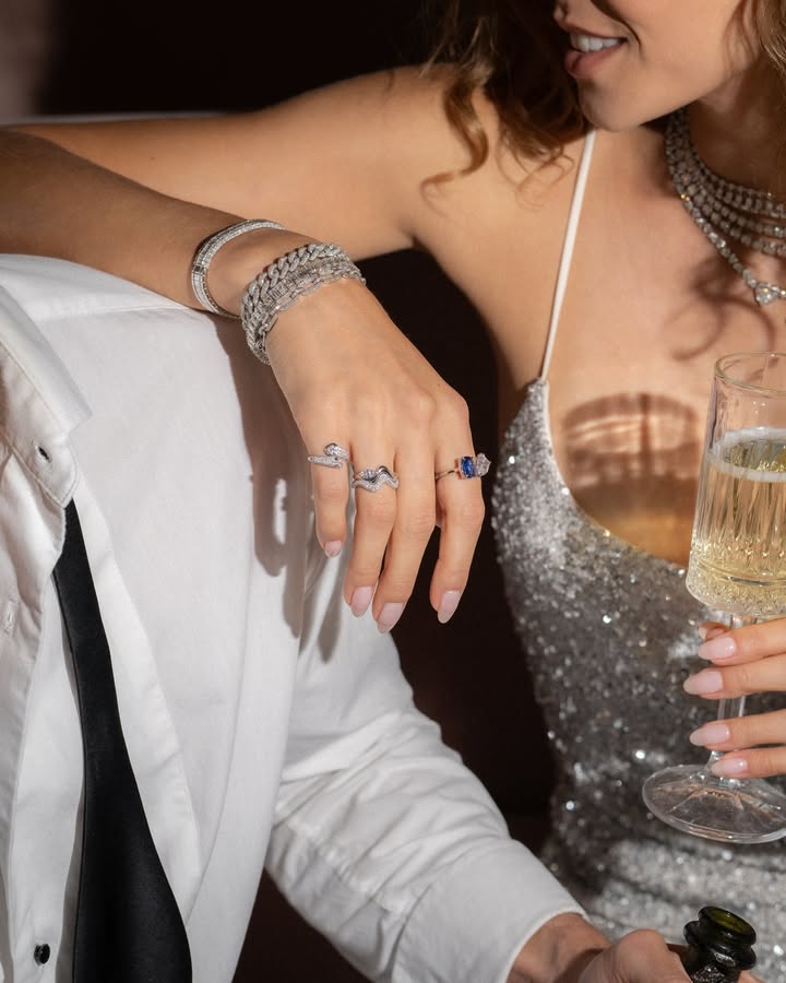May be an image of ring, champagne, wrist watch and text