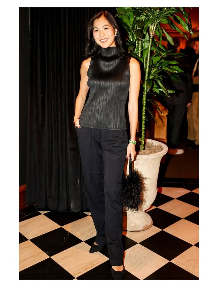 May be an image of turtleneck, jumpsuit and text