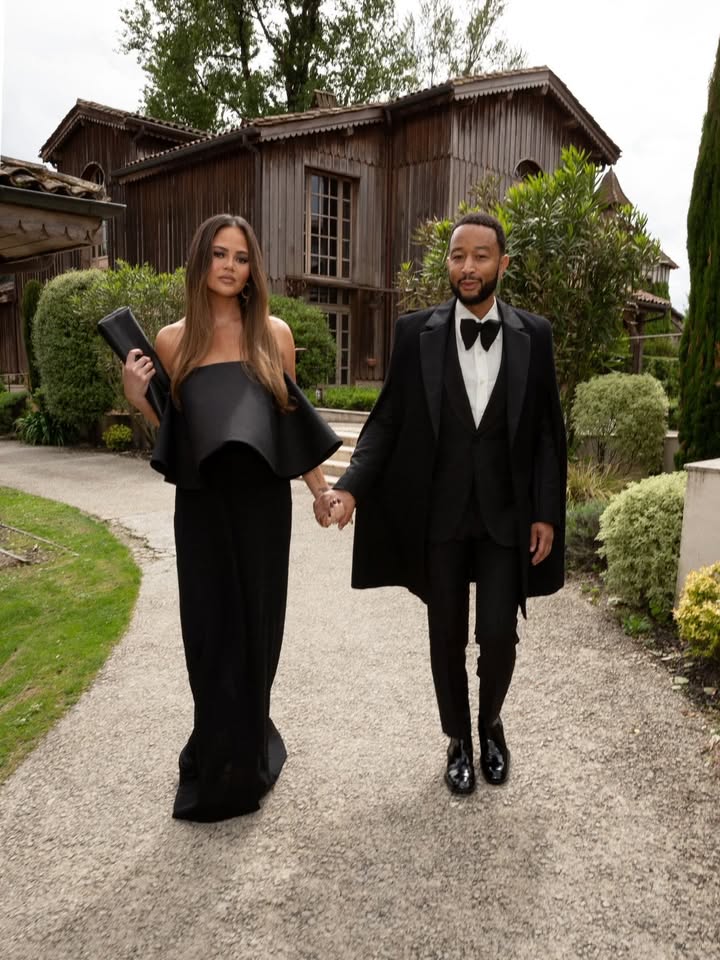 May be an image of suit, gown, dinner jacket, overskirt, wedding and text