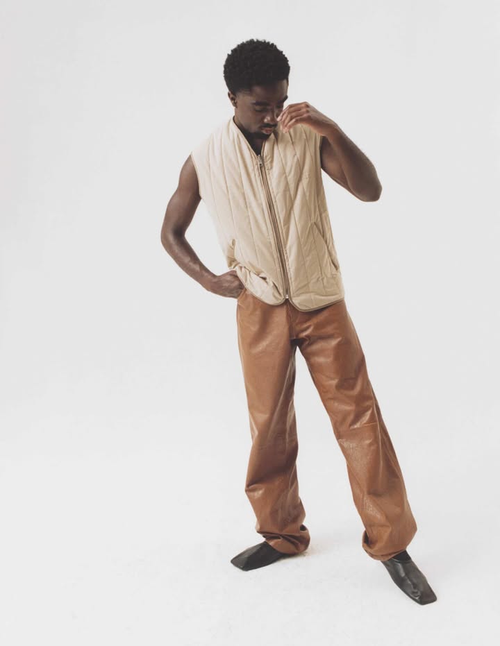 May be an image of vest, turtleneck and text