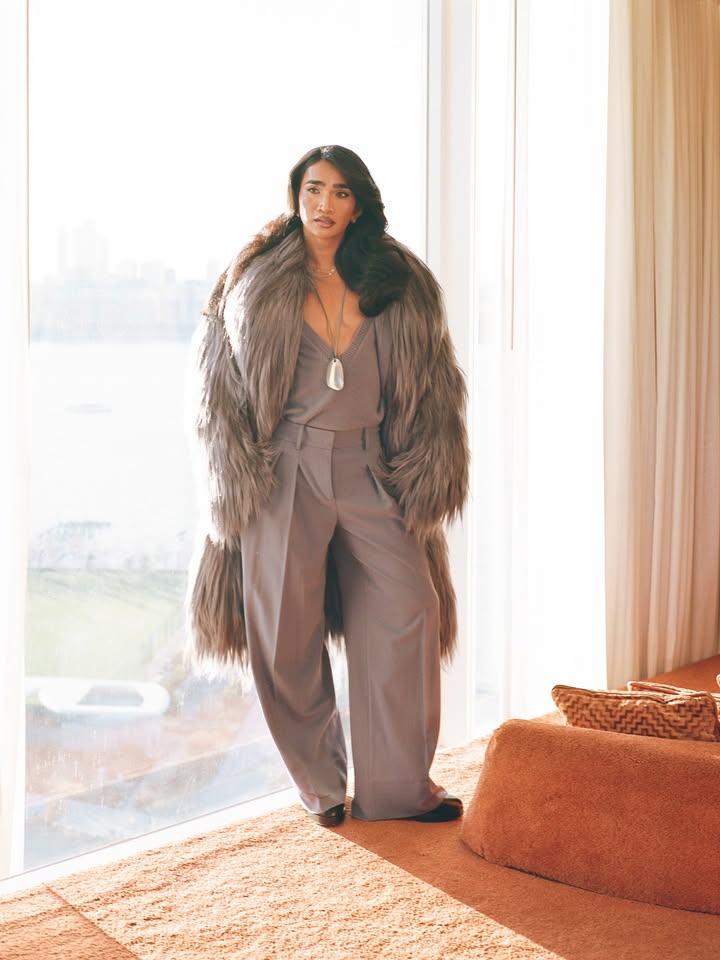 May be an image of one or more people, makeup, fur coat, goosedown coat, jumpsuit and text