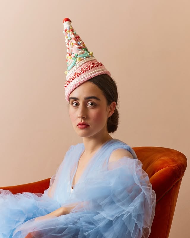 May be an image of one or more people, makeup, headdress and text