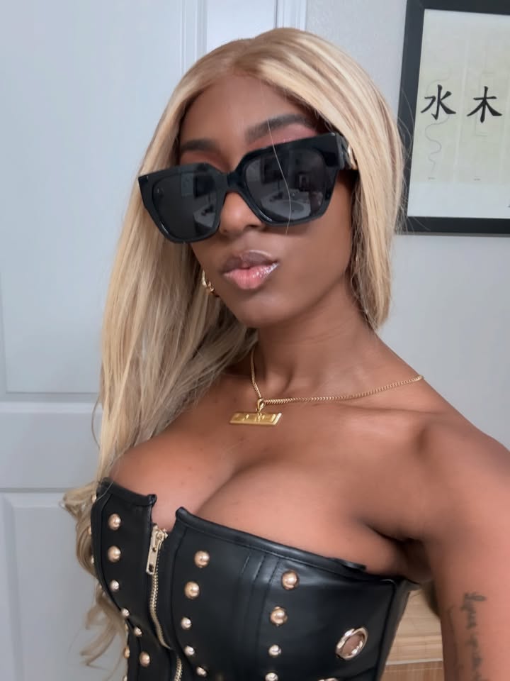 May be an image of one or more people, blonde hair, makeup, sunglasses and text