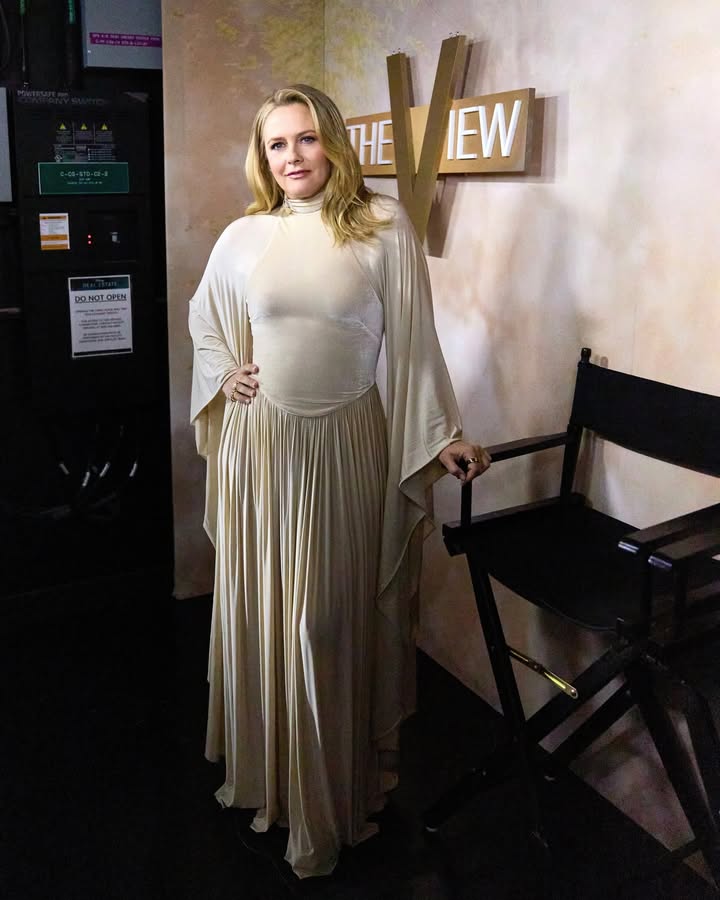 May be an image of dress, costume and text