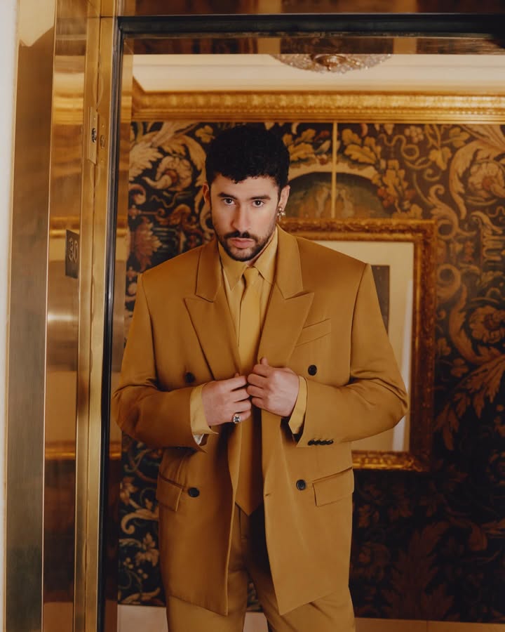 May be an image of suit, overcoat, dinner jacket, blazer and text