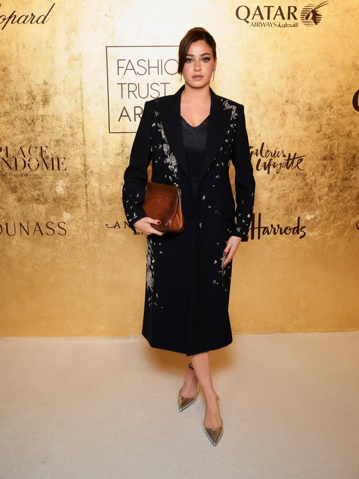 May be an image of dress, carpet, blazer and text