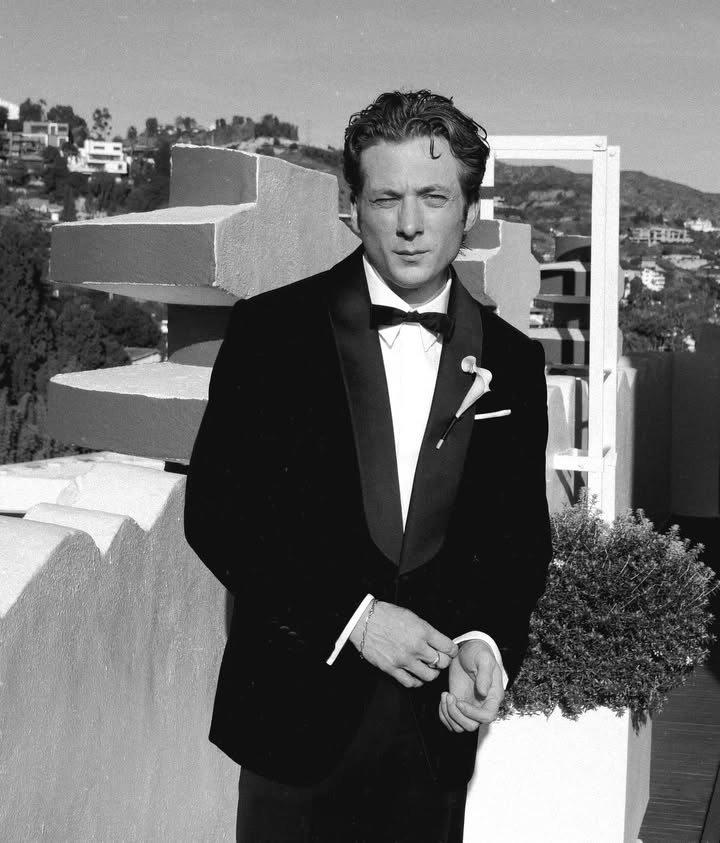 May be a black-and-white image of one or more people, suit, dinner jacket and text