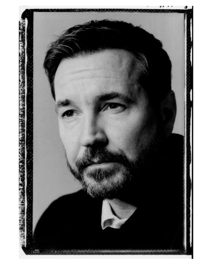 May be a black-and-white image of one or more people, poster and text