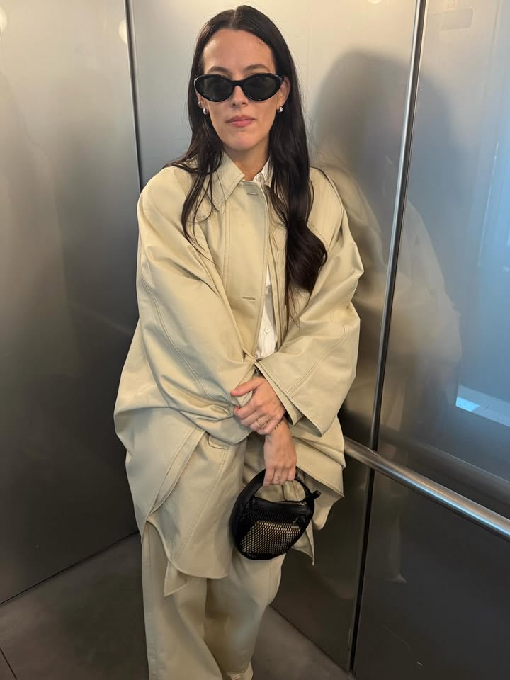 May be an image of overcoat, suit and text