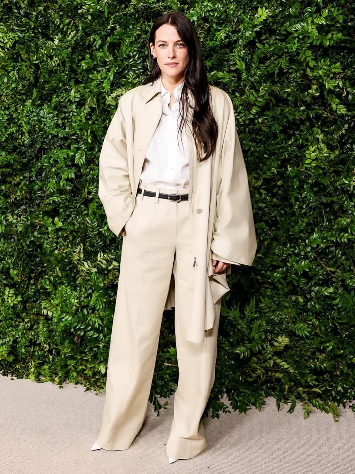 May be an image of overcoat and text