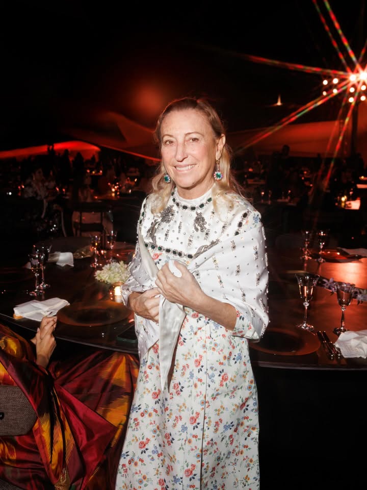 May be an image of one or more people, dress and text