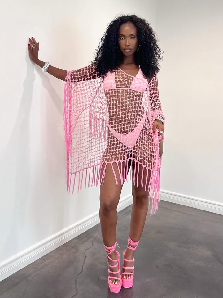 May be an image of poncho, dress and text