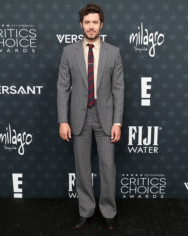 May be an image of one or more people, suit, carpet, dinner jacket and text that says '31#ANNUAL 13 0IEVERS VERSOT T ITICS HOICE VERS ARDS R AR ARD milago Tequila RSANT E nilazo Tequila FIJI WATER E F W, *** 31ANNUAL CRITICS CHOICE AWARDS A WARD S'