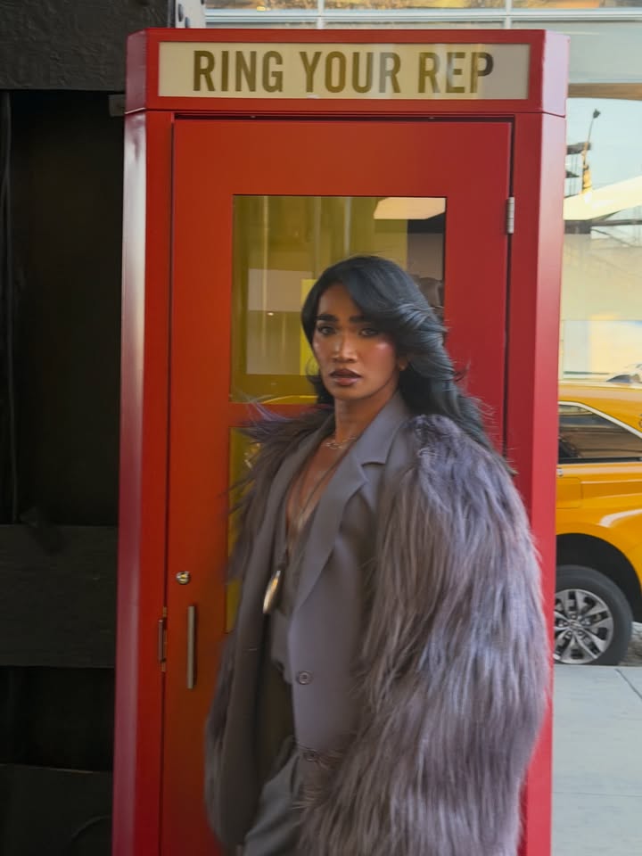 May be an image of one or more people, makeup, phone, parking meter, fur coat, overcoat, blazer, telephone, cash machine, suit and text that says 'RING YOUR REP'