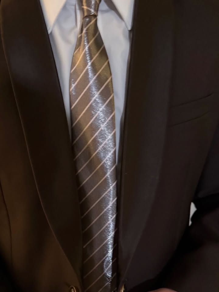 May be an image of suit, neckwear, dinner jacket and text