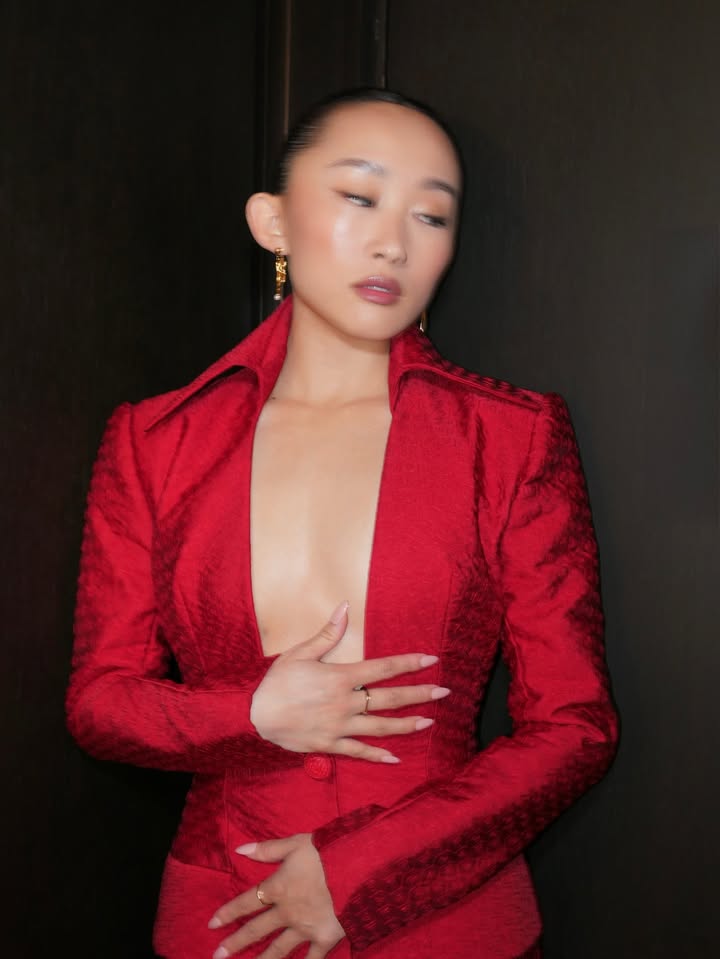 May be an image of one or more people, makeup, suit, blazer and text