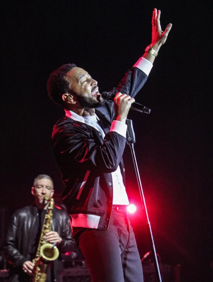 May be an image of saxophone, microphone, concert and text