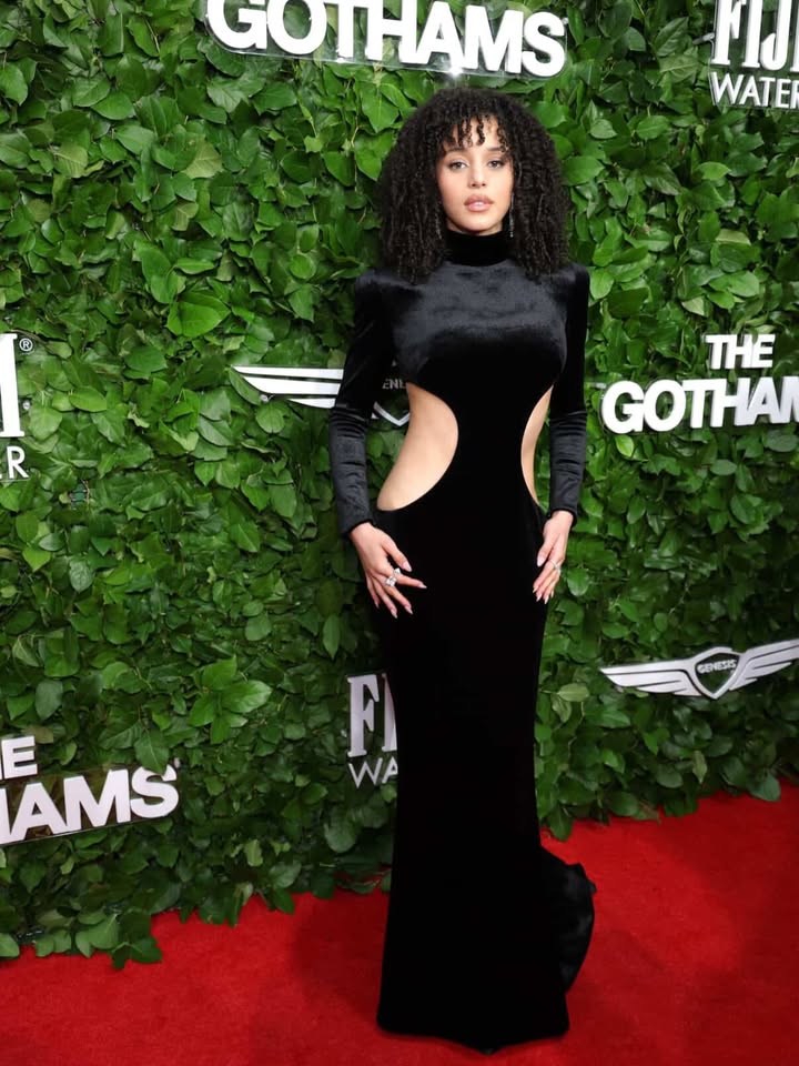 May be an image of one or more people, makeup, carpet, gown and text that says 'GOTHAMS Fid WATEI R THE GOTHA GENESIS AMS E F WA'