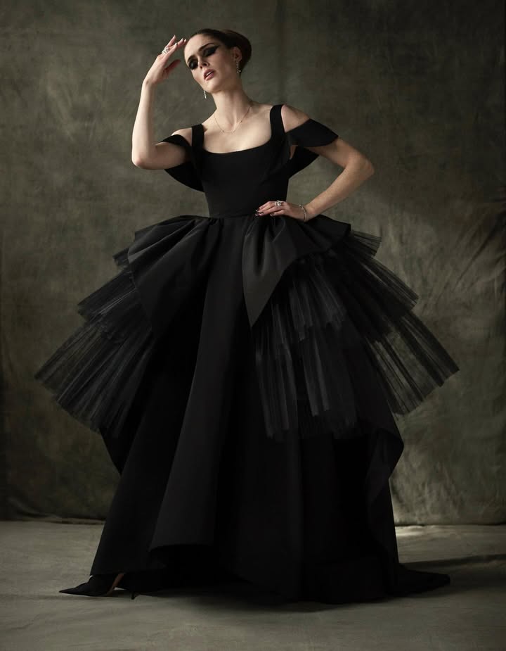 May be an image of gown, dress and text