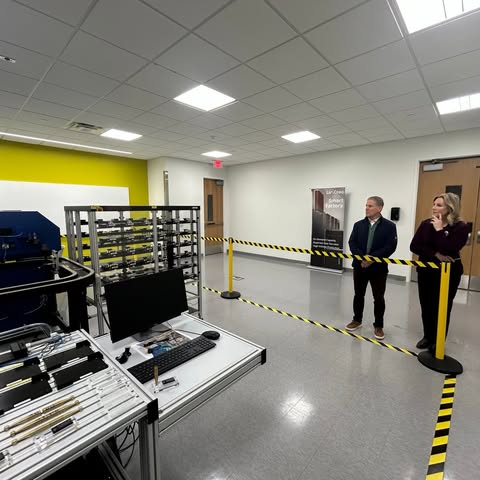 May be an image of standing, rack, office and text