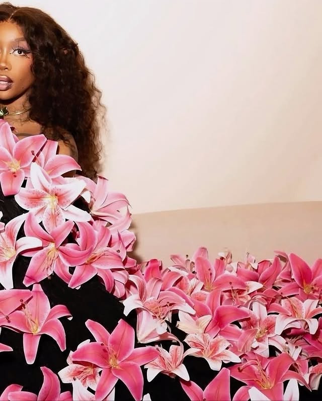 May be an image of one or more people, makeup, flower, lily and text