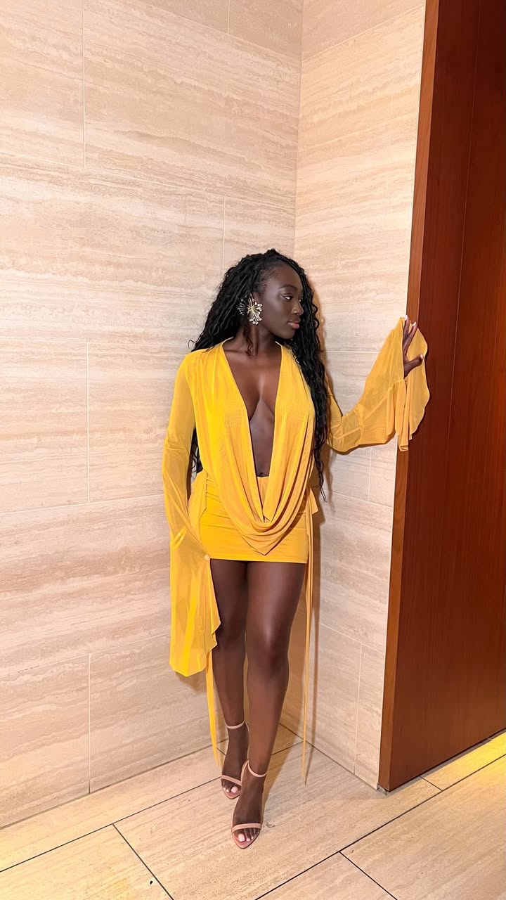 May be an image of one or more people, robe, dress, sundress and text