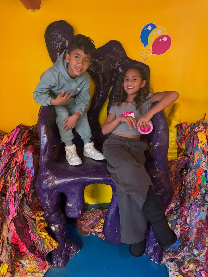 May be an image of child, bubble gum, smiling, lollipop, lego, brick wall and text