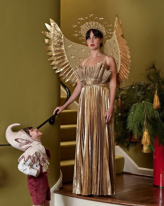 May be an image of child, makeup, headdress, tinsel and text