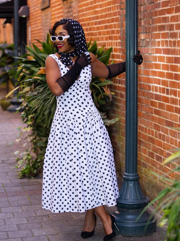 May be an image of headscarf, dress, parasol, beret and text